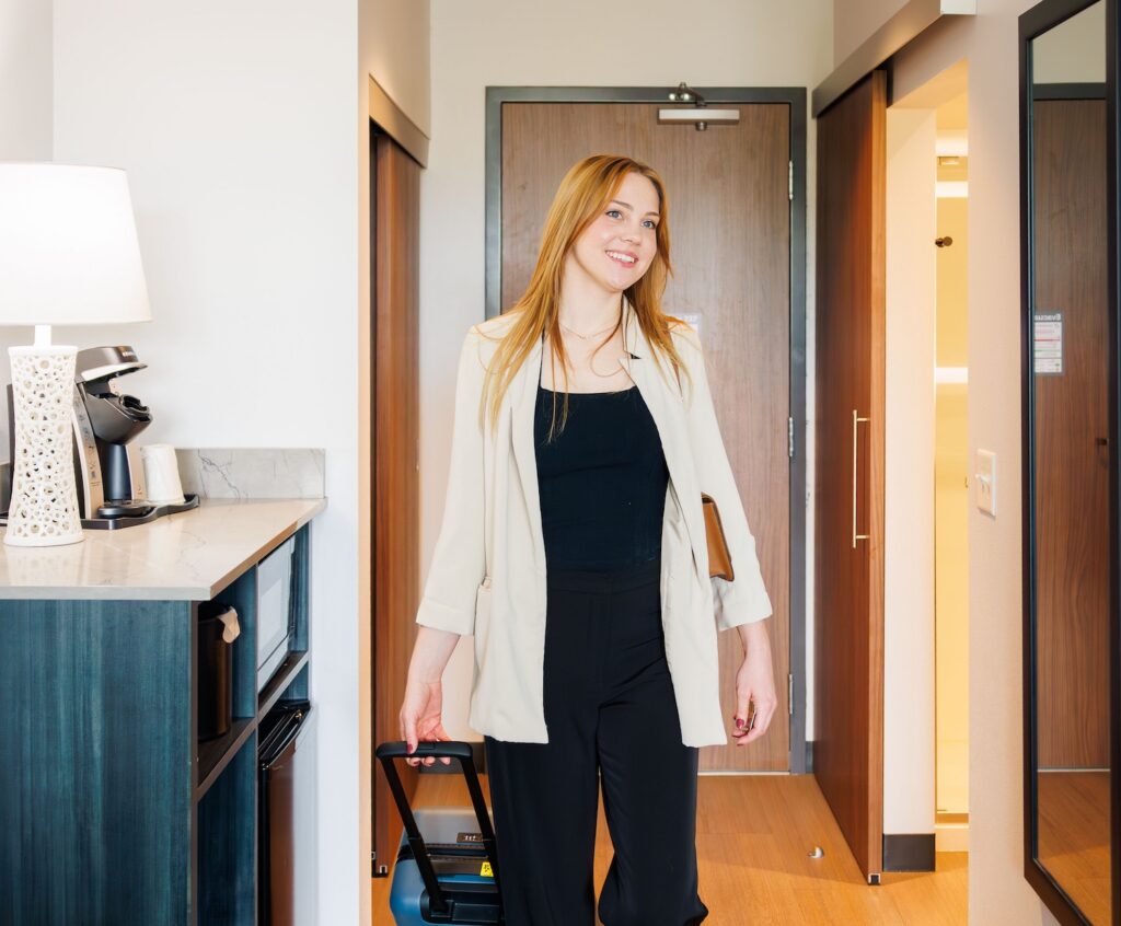 Woman entering room at Hayward Inn in Eugene, Oregon